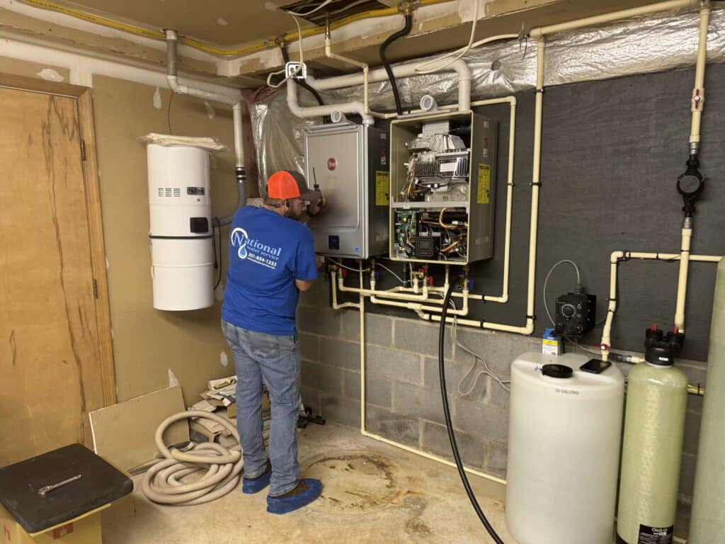 Tankless Water Heater 1 A Man Working On A Machine